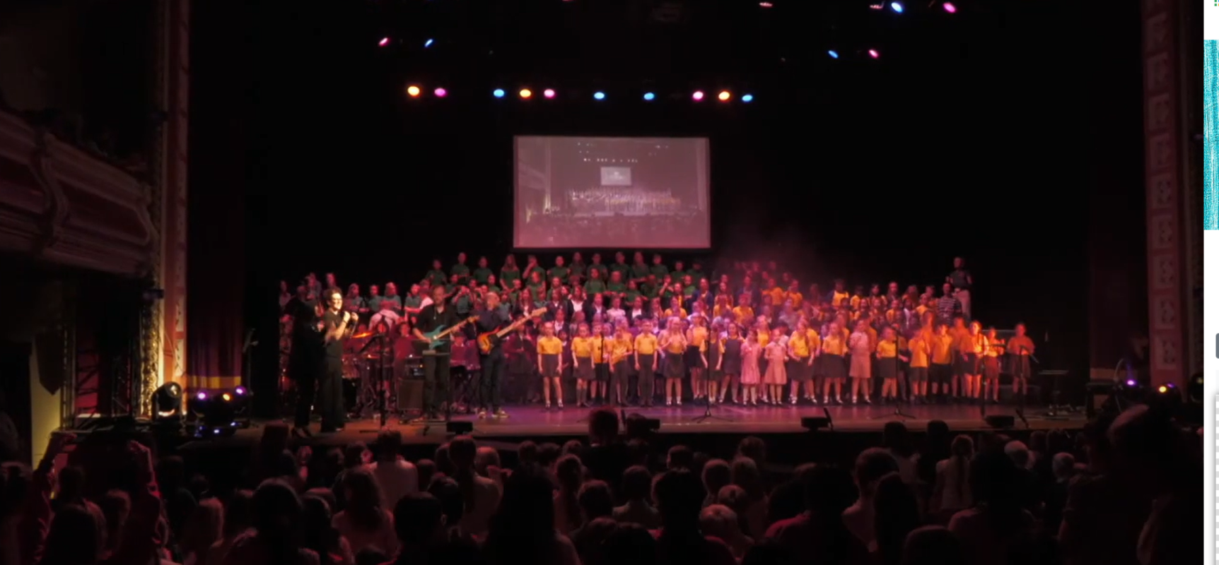 Voices Together schools performing on stage