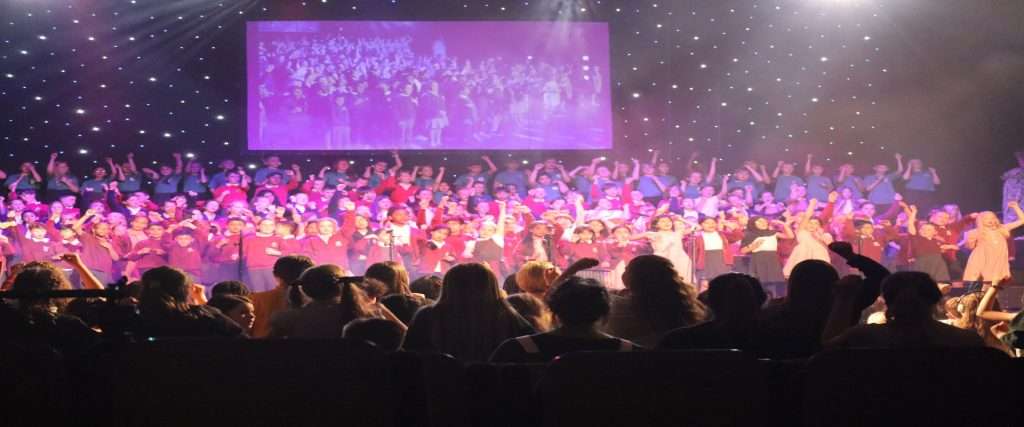 Voices Together schools group photo on stage