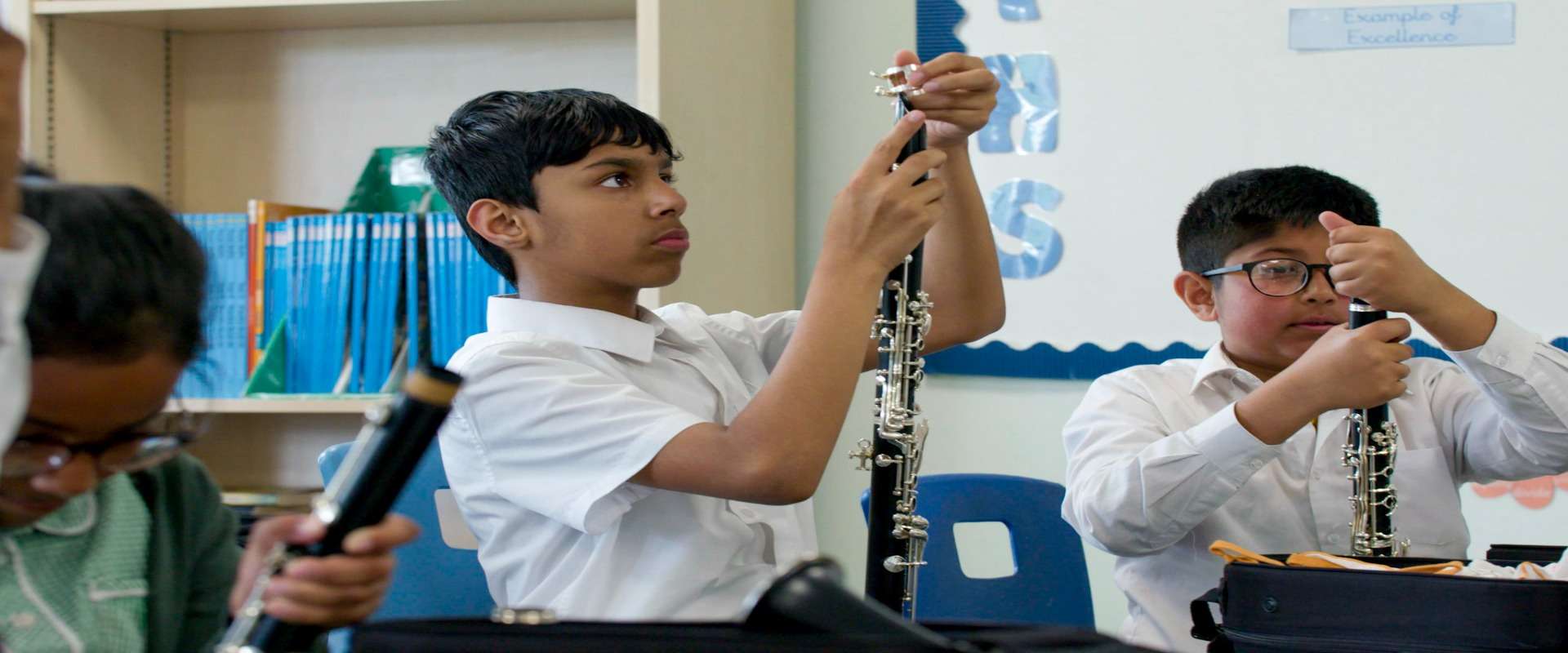 Some school students setting up clarinets ready to play